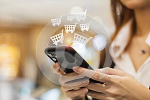 woman using smartphone shopping online, shopping cart icon on screen mobile phone. purchase payment on internet. online