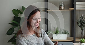 Woman using smartphone talking to friend on speakerphone