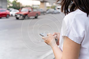 Woman using smartphone for a taxi