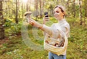 Woman using smartphone to identify mushroom