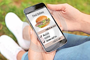 Woman using smartphone to order food delivery