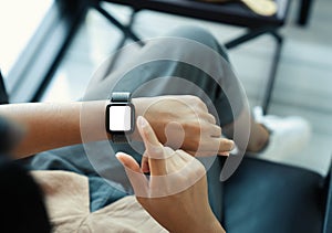 Woman using smartwatch blank screen on top view