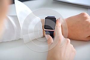 woman using smartwatch and working