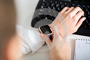 woman using smartwatch and working