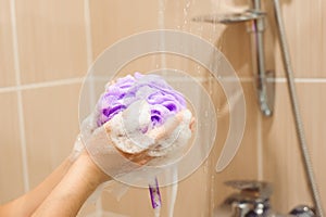 Woman using a soap while taking shower in bathroom