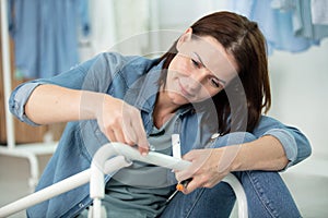 woman using strew driver for assembling furniture