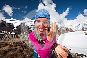 Woman is using sun protection cream in mountains on the way to A