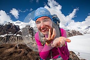 Woman is using sun protection cream in mountains on the way to A