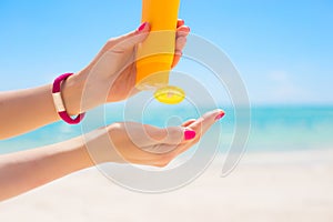Woman using sunscreen on the beach photo