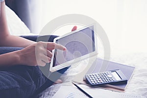 Woman using tablet in bedroom, calendar apps, vintage.