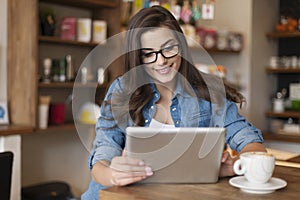 Woman using tablet in cafe