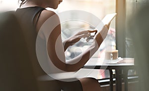 Woman using tablet in coffee shop