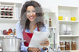 Woman Using Tablet Computer Cooking in Kitchen