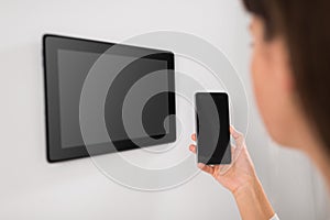 Woman using tablet computer and smartphone