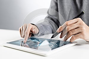 Woman using tablet computer for stock trading