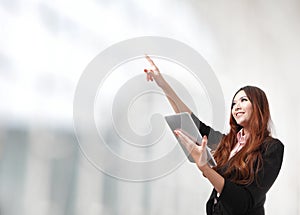 Woman using tablet pc and finger point copy space