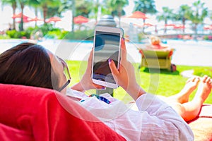 Woman using tablet on summer holidays