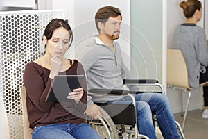 woman using tablet in waiting room