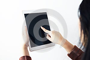 A woman is using tablet with white background