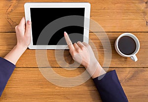 Woman using tablet at workplace, top view, close up