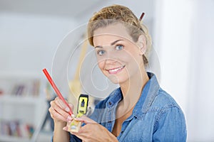 Woman using tape measure for diy