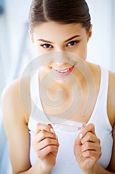 Woman Using Teeth Whitening Strip For Beautiful White Smile. High Resolution Image