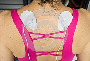 Woman using a TENS Unit