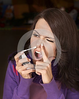 Woman using throat spray.