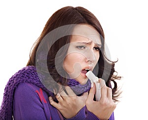 Woman using throat spray.