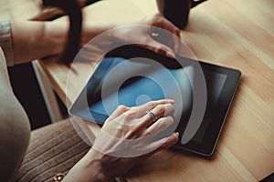 Woman using a touch screen tablet hands close up. Ipad