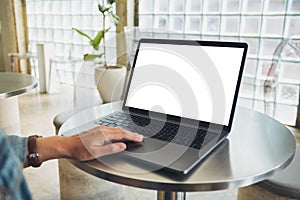 A woman using and touching on laptop computer touchpad with blank white desktop screen