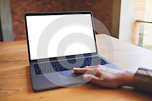 A woman using and touching on laptop touchpad with blank white desktop screen