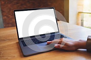 A woman using and touching on laptop touchpad with blank white desktop screen