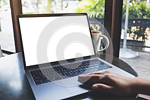 A woman using and touching on laptop touchpad with blank white desktop screen