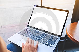 a woman using and touching on laptop touchpad with blank white desktop screen