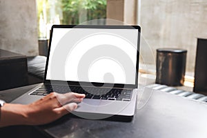 A woman using and touching on laptop touchpad with blank white desktop screen