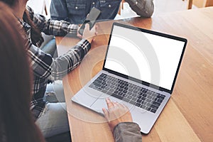 A woman using and touching on mockup laptop computer touchpad