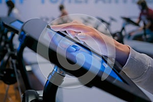 Woman using touchscreen display of floor standing black tablet kiosk: close up