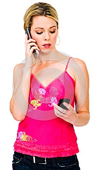 Woman using two mobile phones