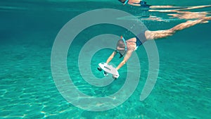 Woman using underwater scooter for diving. Modern sea scooter, modern technology concept.