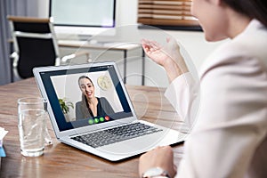 Woman using video chat for online job interview in office