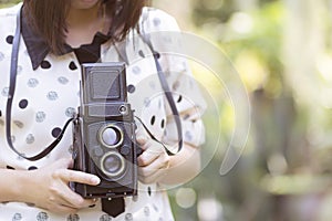 Woman using vintage camera taking photos