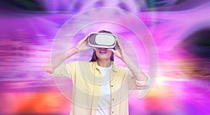 Woman using virtual reality headset and getting in simulated futuristic world