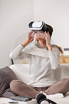 Woman using the virtual reality headset at home