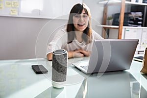 Woman Using Voice Assistant In Office photo