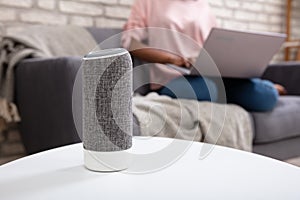 Woman Using Voice Assistant  Speaker