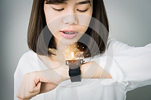 Woman using voice commands in digital clock in the display and technology advances in communication.