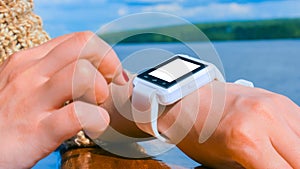 Woman using wearable smart watch with white empty display