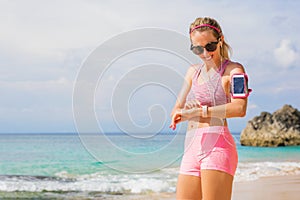 Woman using wearable tech while exercising outdoors