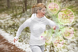 Woman using wearable tech during running workout outdoors